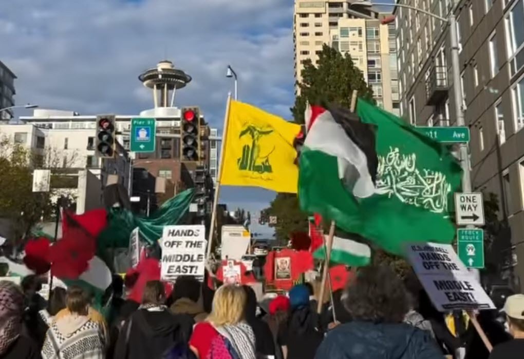 The flags of U.S.-designated terror groups Hezbollah and Hamas are flown during an anti-Israel protest in Seattle, WA, on October 5, 2024. (source: Instagram)
