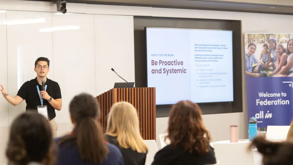 Person presenting to a group of people standing by a podium