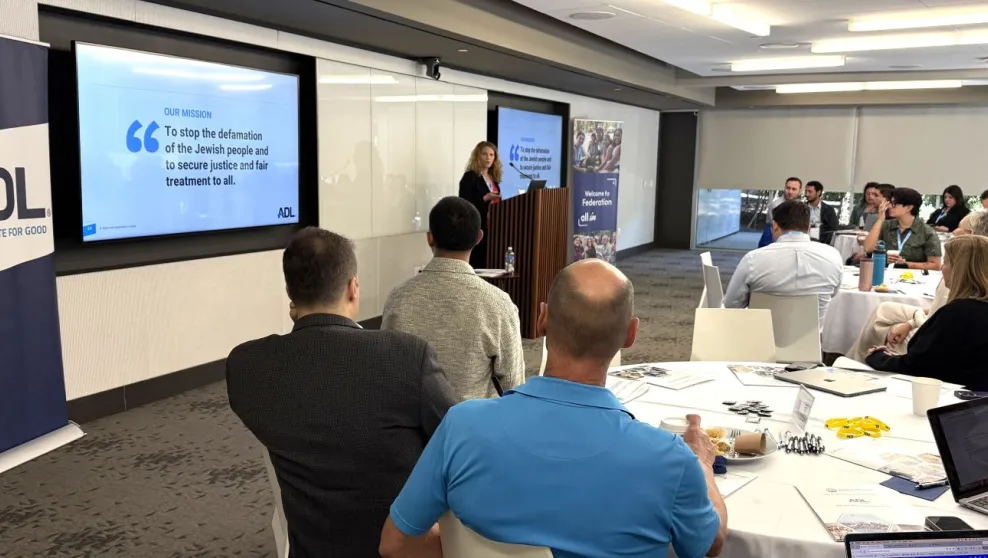 A woman at a podium presenting to an audience