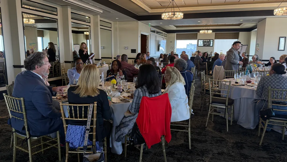 Attendees at the Passover Seder event sitting on round tables