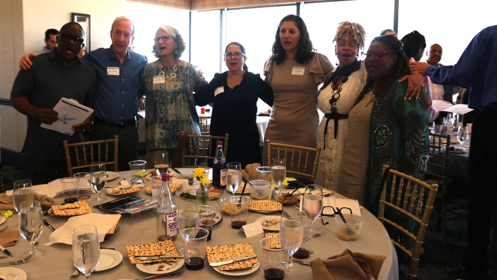 Attendees at the Together Towards Freedom Black Jewish Passover Seder gathered around tables, joining in song